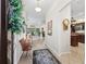 Inviting foyer with tile flooring, decorative rug, and views into the living spaces and kitchen at 3540 O'Brien Pl, The Villages, FL 32163