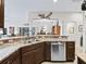 Kitchen with stainless steel appliances, dark cabinets, and a view into the dining area at 3540 O'Brien Pl, The Villages, FL 32163