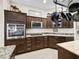 Kitchen featuring dark wood cabinets, stainless steel appliances, and granite countertops at 3540 O'Brien Pl, The Villages, FL 32163