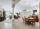 Open-concept living space featuring elegant furnishings and dining area with decorative lighting at 3540 O'Brien Pl, The Villages, FL 32163