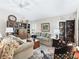 Cozy living room featuring comfortable furniture, a decorative rug, and a built-in bookshelf at 3540 O'Brien Pl, The Villages, FL 32163