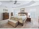 Inviting main bedroom featuring tray ceiling, shuttered windows, and ample storage at 3540 O'Brien Pl, The Villages, FL 32163