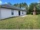 The back of the home featuring a sliding glass door and backyard view at 390 Colonade Ct, Kissimmee, FL 34758