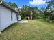 Expansive backyard featuring a patio and lush greenery, perfect for outdoor activities and relaxation at 390 Colonade Ct, Kissimmee, FL 34758