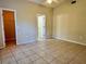 Neutral bedroom boasts tile flooring, providing a cool and clean aesthetic at 390 Colonade Ct, Kissimmee, FL 34758