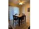 Cozy dining area featuring tile flooring and a table set for four, complemented by natural lighting at 390 Colonade Ct, Kissimmee, FL 34758