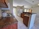 A well-lit kitchen with a stainless steel sink, stove, and wooden cabinets at 390 Colonade Ct, Kissimmee, FL 34758