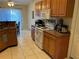 This kitchen features tiled flooring, matching cabinets, and white appliances at 390 Colonade Ct, Kissimmee, FL 34758