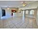 A large living room featuring tile floors, high ceilings, and a view of the kitchen at 390 Colonade Ct, Kissimmee, FL 34758