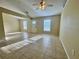 Bright living area showcases tile flooring and windows, offering comfortable living at 390 Colonade Ct, Kissimmee, FL 34758