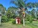 Outdoor shed surrounded by lush trees and greenery at 390 Colonade Ct, Kissimmee, FL 34758