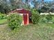 Outdoor shed surrounded by well-maintained lawn and mature landscaping at 390 Colonade Ct, Kissimmee, FL 34758