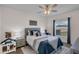 Comfortable bedroom features a cozy bed with decorative pillows and a window offering natural light at 3935 Fescue St, Clermont, FL 34714