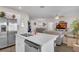 This kitchen features a quartz countertop island, stainless steel appliances and views to the dining and living areas at 3935 Fescue St, Clermont, FL 34714