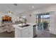 This kitchen features a quartz countertop island, stainless steel appliances and sliding door access to the lanai at 3935 Fescue St, Clermont, FL 34714