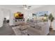 Bright living room featuring a comfy sofa set, hardwood floors, and a large window for natural light at 3935 Fescue St, Clermont, FL 34714