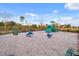 Community playground with slides, spring riders and soft landing surface in a fenced in area at 3935 Fescue St, Clermont, FL 34714