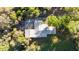 Aerial view of a home with a gray roof and surrounding trees at 39615 Forest Dr, Eustis, FL 32736