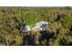 Aerial view of a single story home bordering a tranquil lake at 39615 Forest Dr, Eustis, FL 32736