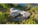 Overhead angle of a home with a large driveway and a well-maintained gray roof at 39615 Forest Dr, Eustis, FL 32736