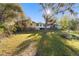 Expansive backyard view showcasing the home's exterior and mature trees at 39615 Forest Dr, Eustis, FL 32736