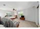 Well-lit bedroom showcasing a bed, chair, and television set for entertainment at 39615 Forest Dr, Eustis, FL 32736