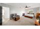 Comfortable bedroom featuring a ceiling fan, chair, and ample natural light from the window at 39615 Forest Dr, Eustis, FL 32736