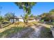 View of single-story home featuring verdant yard and serene surroundings at 39615 Forest Dr, Eustis, FL 32736