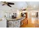 Bright living room with ceiling fans, wood floors, and French doors to the outdoors at 39615 Forest Dr, Eustis, FL 32736