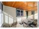 Cozy porch with tile floor and wood ceiling, perfect for relaxing and enjoying the outdoors at 39615 Forest Dr, Eustis, FL 32736