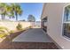 Backyard featuring a concrete patio area with decorative landscaping and a privacy wall at 4036 Venetian Ln, The Villages, FL 32163