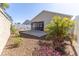 Backyard featuring a concrete patio area, decorative landscaping and a privacy wall at 4036 Venetian Ln, The Villages, FL 32163