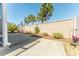 Backyard featuring a concrete patio area with decorative landscaping and a privacy wall at 4036 Venetian Ln, The Villages, FL 32163