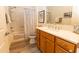 Bathroom with a bathtub and shower combination, a wooden vanity, and a marble countertop at 4036 Venetian Ln, The Villages, FL 32163