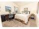 Cozy bedroom with neutral tones, a ceiling fan, and a window offering natural light at 4036 Venetian Ln, The Villages, FL 32163