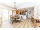 Dining area adjacent to the kitchen featuring a modern light fixture and views of the kitchen and yard at 4036 Venetian Ln, The Villages, FL 32163