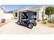 Blue Yamaha Golf Cart parked in front of home with attached garage and manicured landscaping at 4036 Venetian Ln, The Villages, FL 32163