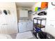 Laundry room with a white washer and dryer, storage cabinets, and a door leading to the outside at 4036 Venetian Ln, The Villages, FL 32163