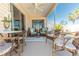 Screened patio with wicker furniture, a ceiling fan, and an outdoor dining area at 4036 Venetian Ln, The Villages, FL 32163