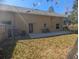 Backyard view highlighting the home's exterior and private patio area with outdoor seating at 42316 E Saffron Ct, Eustis, FL 32736