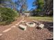 Backyard with firepit surrounded by stone benches and mulch ground cover at 42316 E Saffron Ct, Eustis, FL 32736