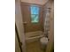 Small bathroom with a tub/shower combo and a window at 42316 E Saffron Ct, Eustis, FL 32736