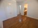 Bedroom with hardwood floors, natural light, and large closet doors at 42316 E Saffron Ct, Eustis, FL 32736