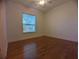 Bedroom with hardwood floors, a ceiling fan, and bright window at 42316 E Saffron Ct, Eustis, FL 32736