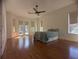 Large main bedroom with hardwood floors, high ceilings, and natural light from windows and French doors at 42316 E Saffron Ct, Eustis, FL 32736