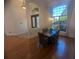 Bright dining area featuring hardwood floors, a hanging light fixture, and a large window at 42316 E Saffron Ct, Eustis, FL 32736