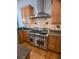 Close up of the kitchen showing stainless steel range, granite countertops, and custom cabinetry at 42316 E Saffron Ct, Eustis, FL 32736