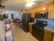 Well-equipped kitchen featuring stainless steel appliances and wood cabinetry at 42316 E Saffron Ct, Eustis, FL 32736