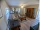 Inviting living room with hardwood floors, a ceiling fan, neutral paint, and natural light at 42316 E Saffron Ct, Eustis, FL 32736