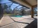 Covered patio overlooking the pool, with a screened enclosure and brick pavers at 42316 E Saffron Ct, Eustis, FL 32736